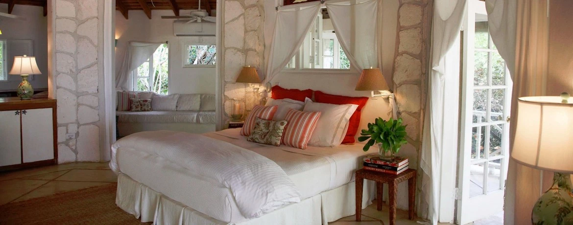 a bedroom with a bed and lamps