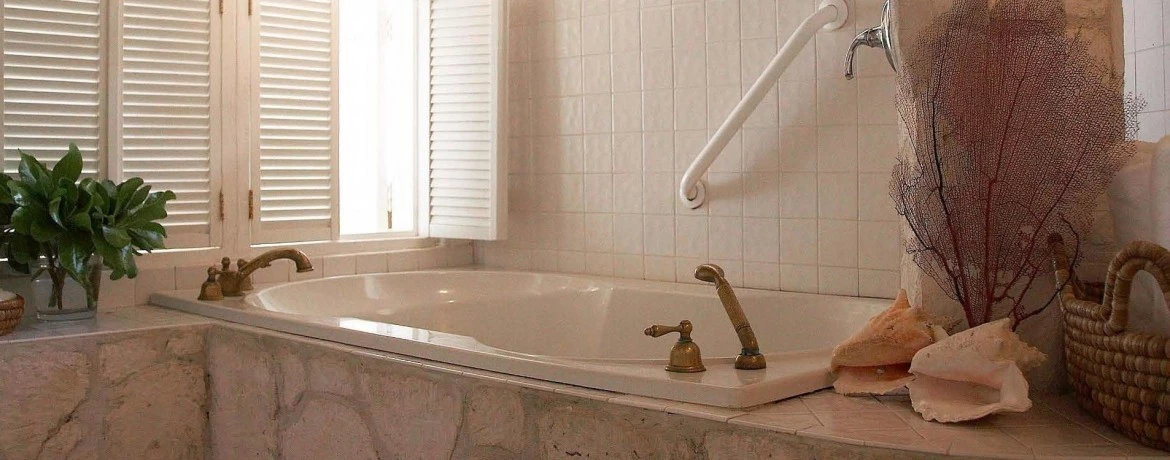 a bathtub with a white towel from it