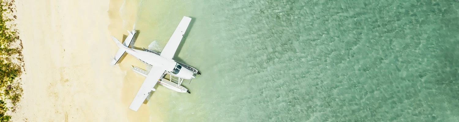 Header Sea Plane landing on a tropical island