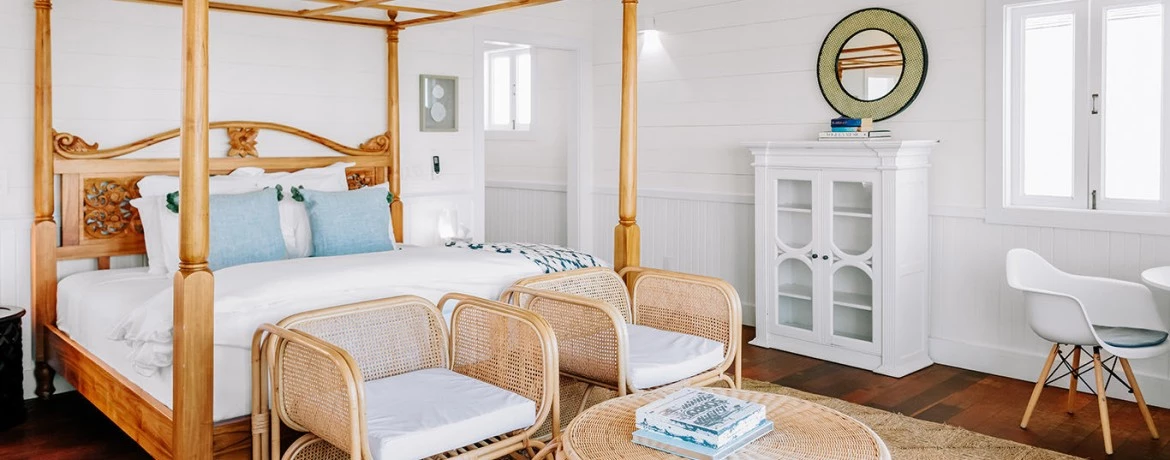 a bedroom with a bed and chairs