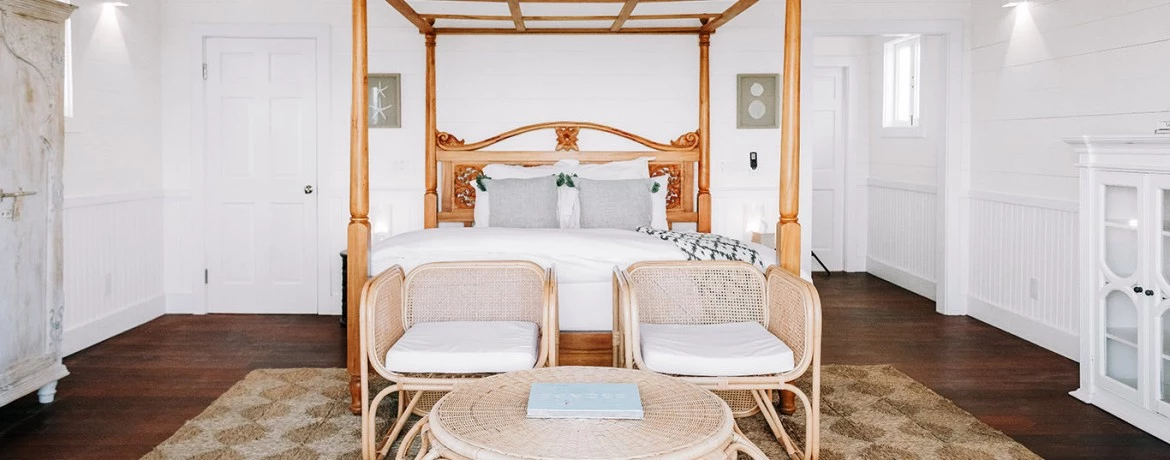 a bed and chairs in a room