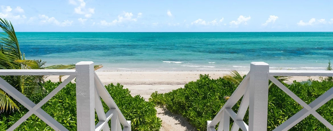 a white railing overlooking a beach