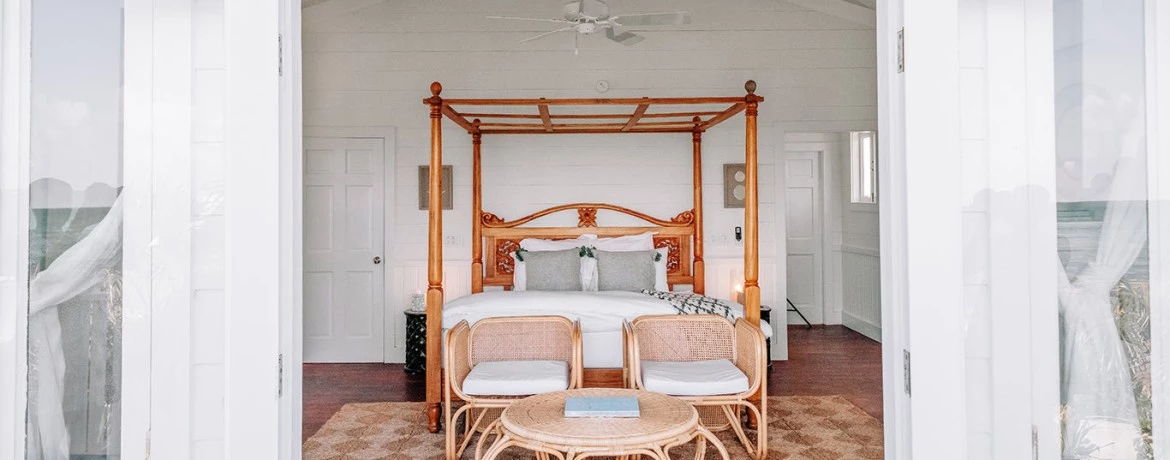 a bedroom with a bed and chairs