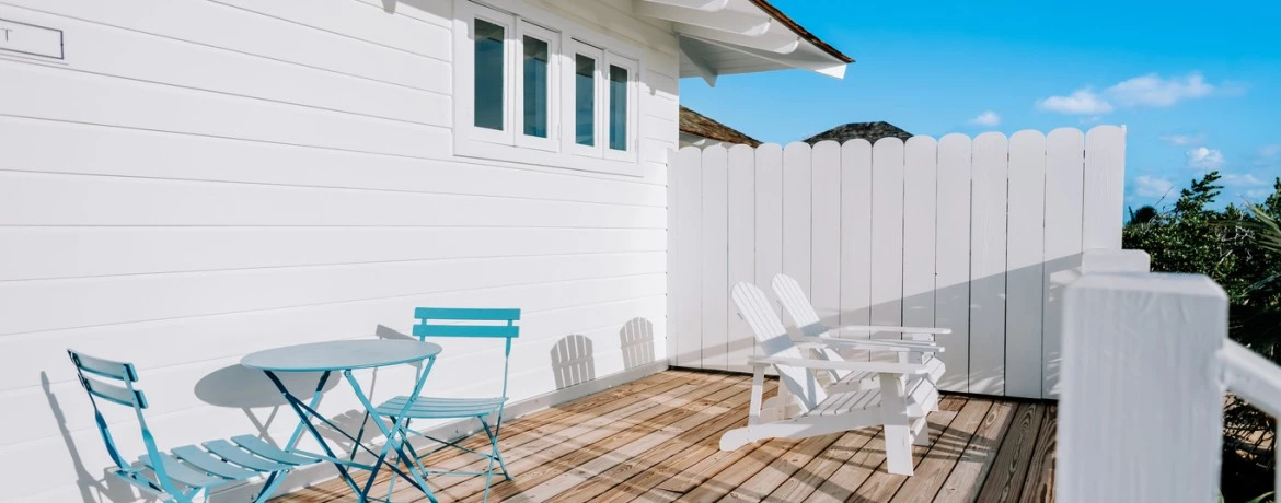 a deck with chairs and a table