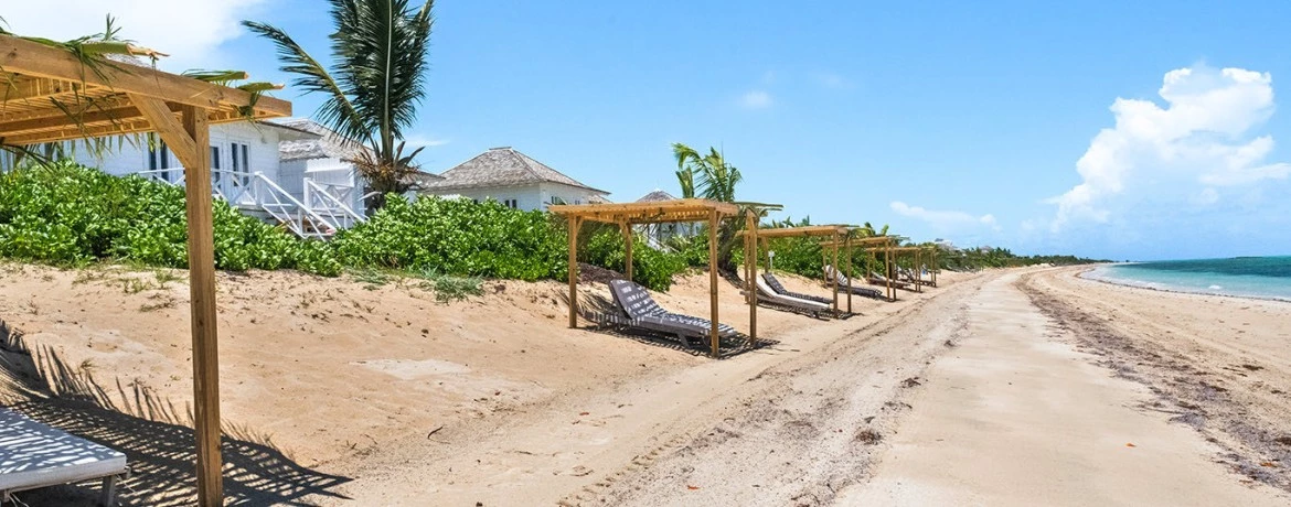 a beach with a gazebo and a body of water