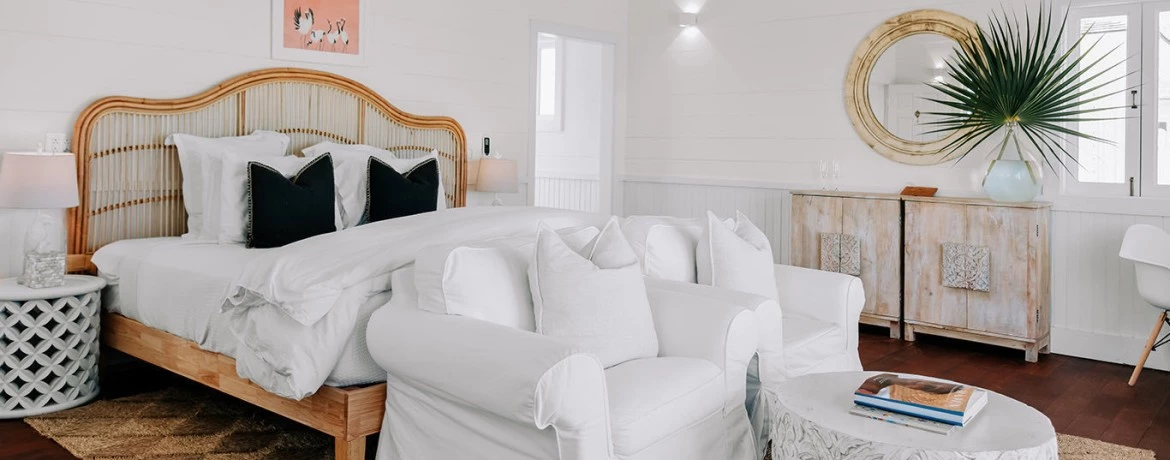 a bedroom with a bed and a chair