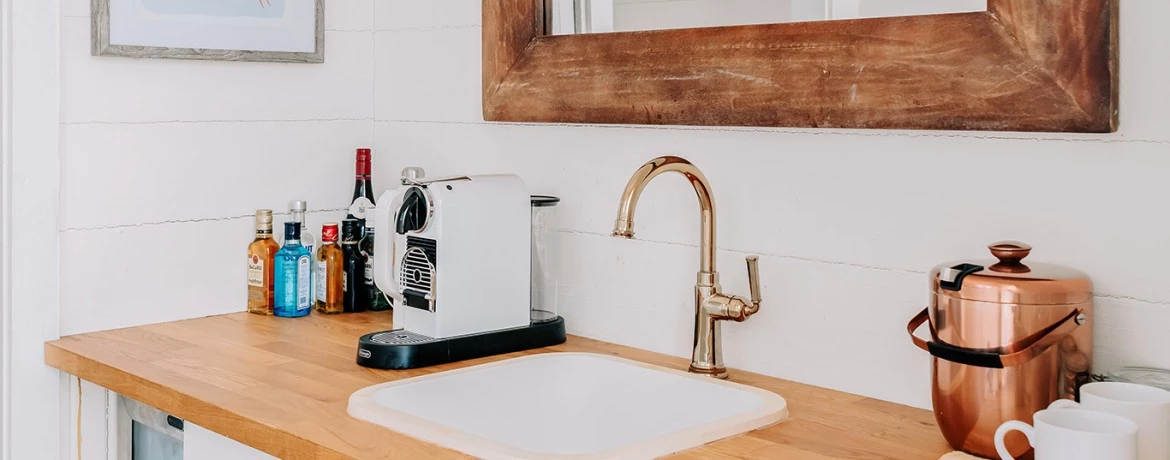 a sink with a tea kettle on it