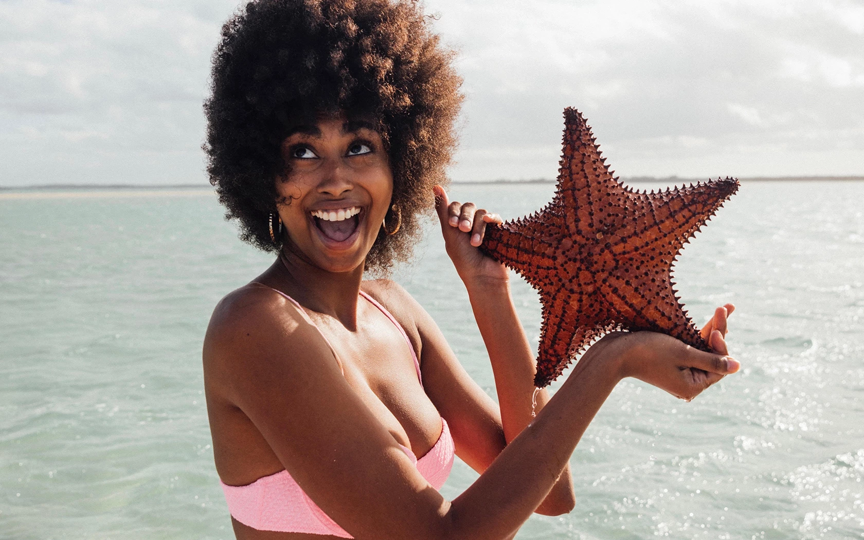 a woman holding a starfish
