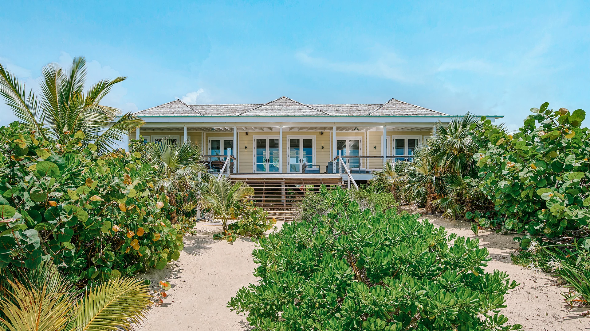 a house with a walkway and bushes