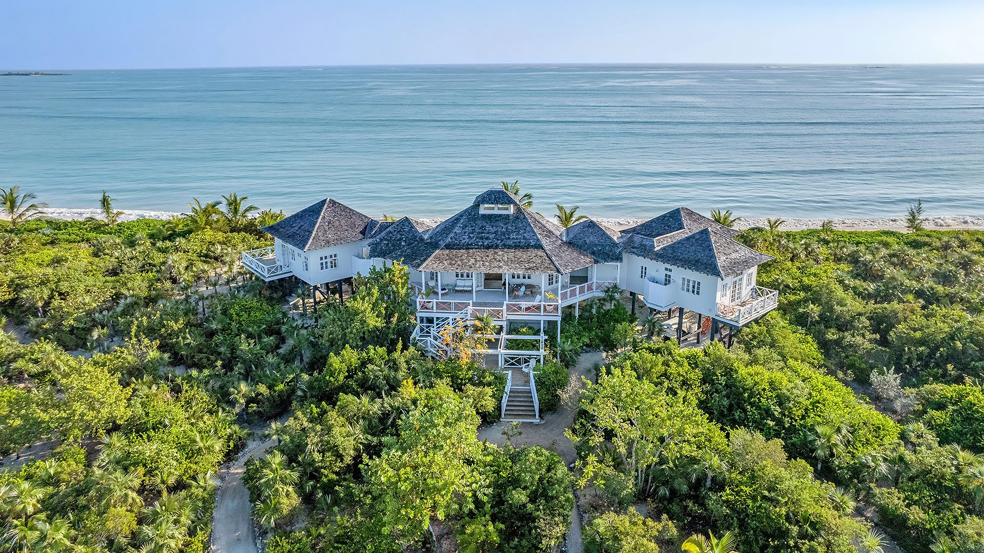 a house with a walkway and bushes