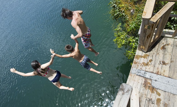 a group of people jumping into water
