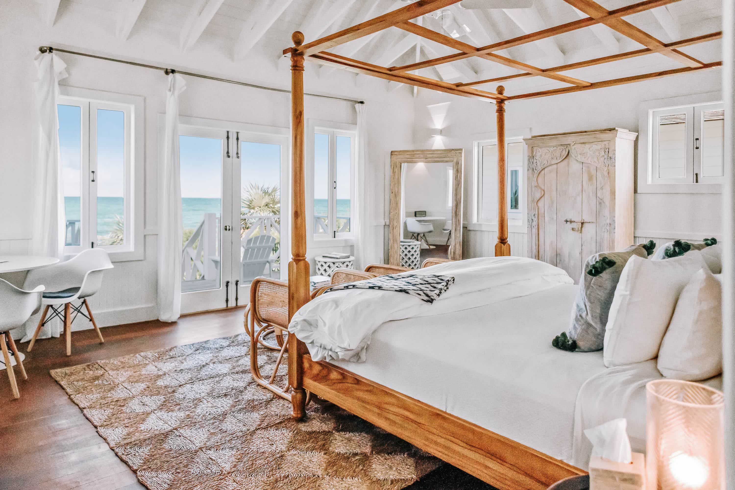 a bedroom with a four poster bed and a rug