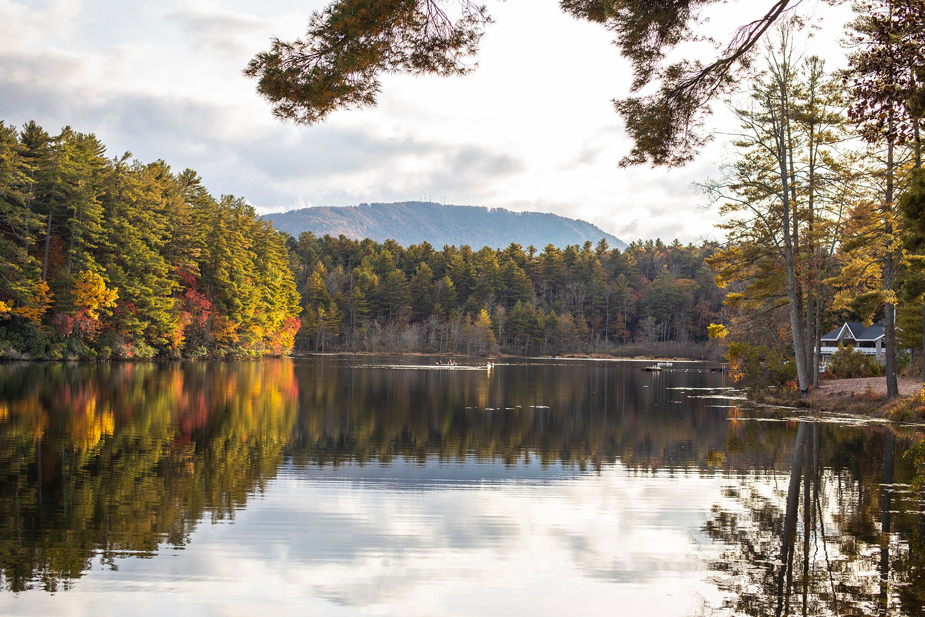 a lake with trees and mountains in the background