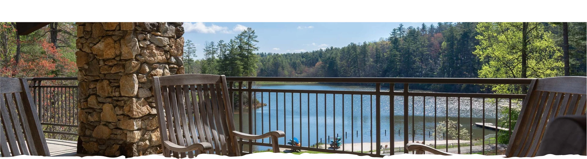a chair on a deck overlooking a lake