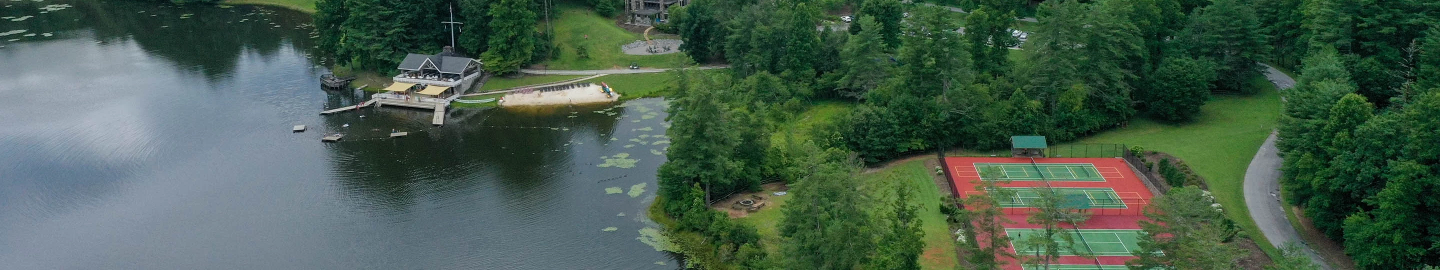 a body of water with trees and buildings around it