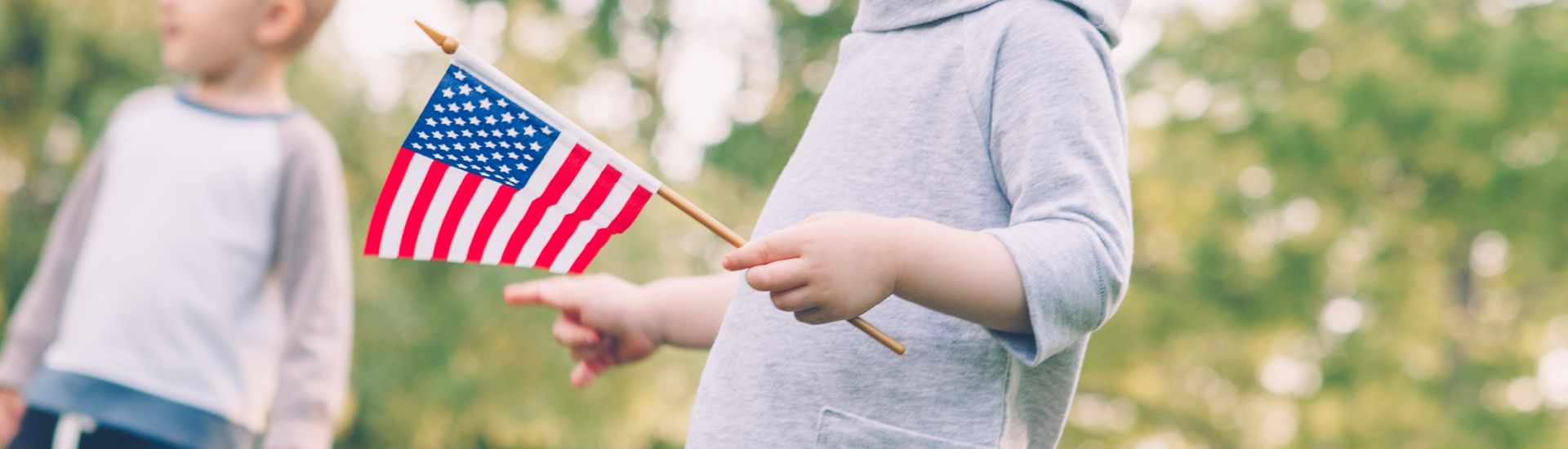 a child holding a small flag