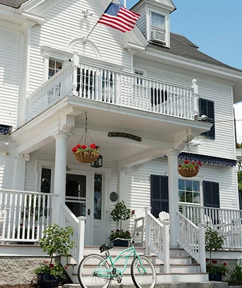 a white house with a flag on the front