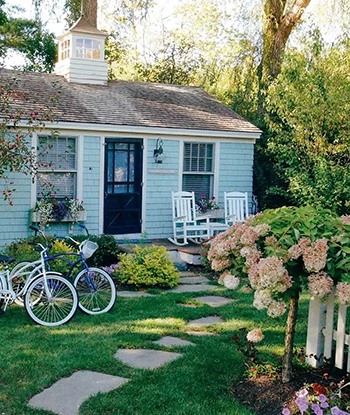 a house with a lawn and a bike
