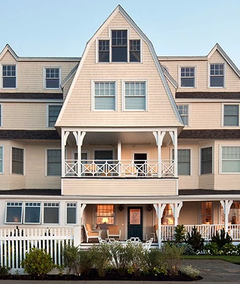 a large house with a lawn and a fence