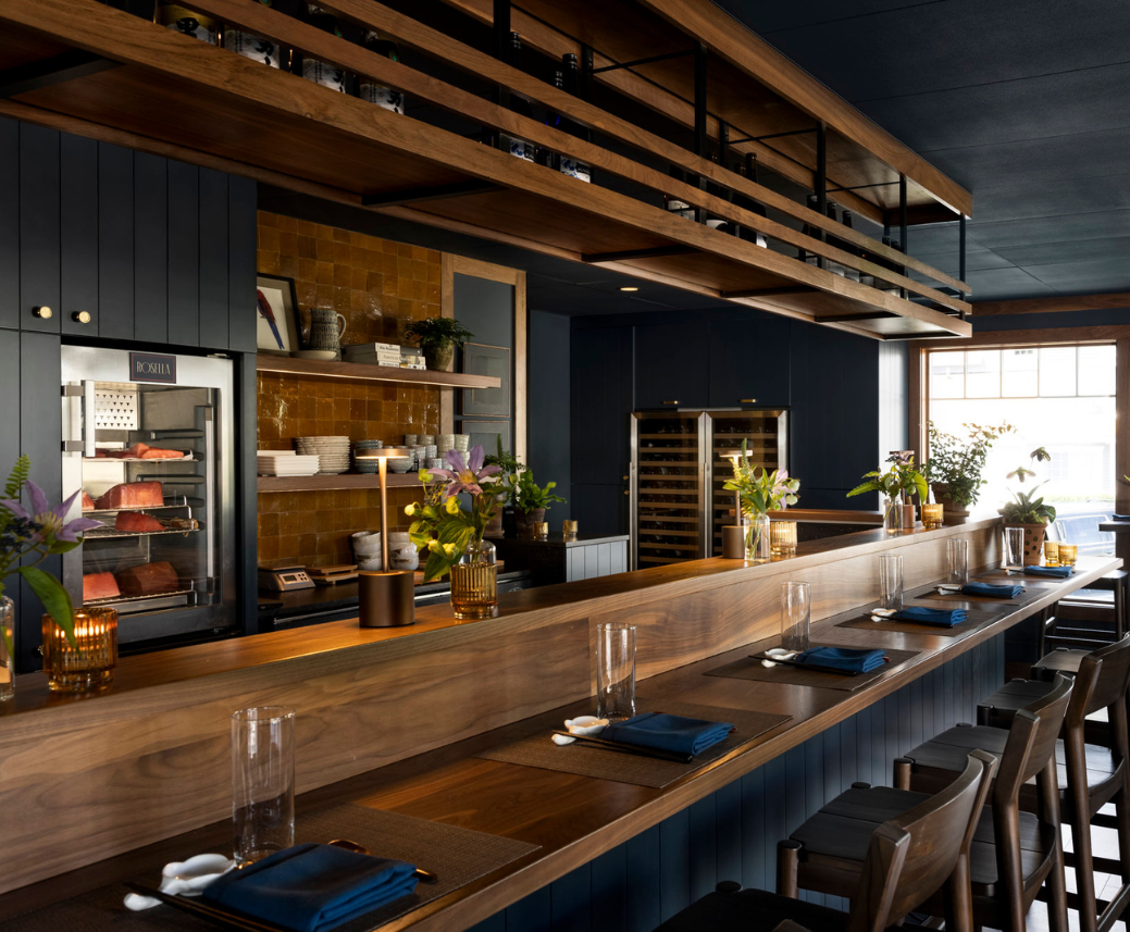 a restaurant with long wooden tables and chairs