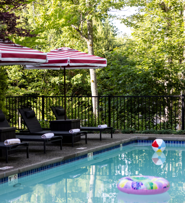 a pool with chairs and umbrellas