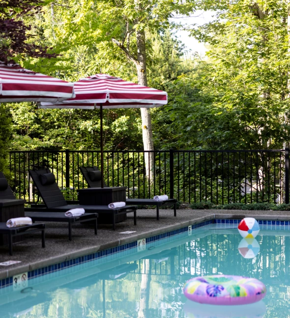 a pool with chairs and umbrellas