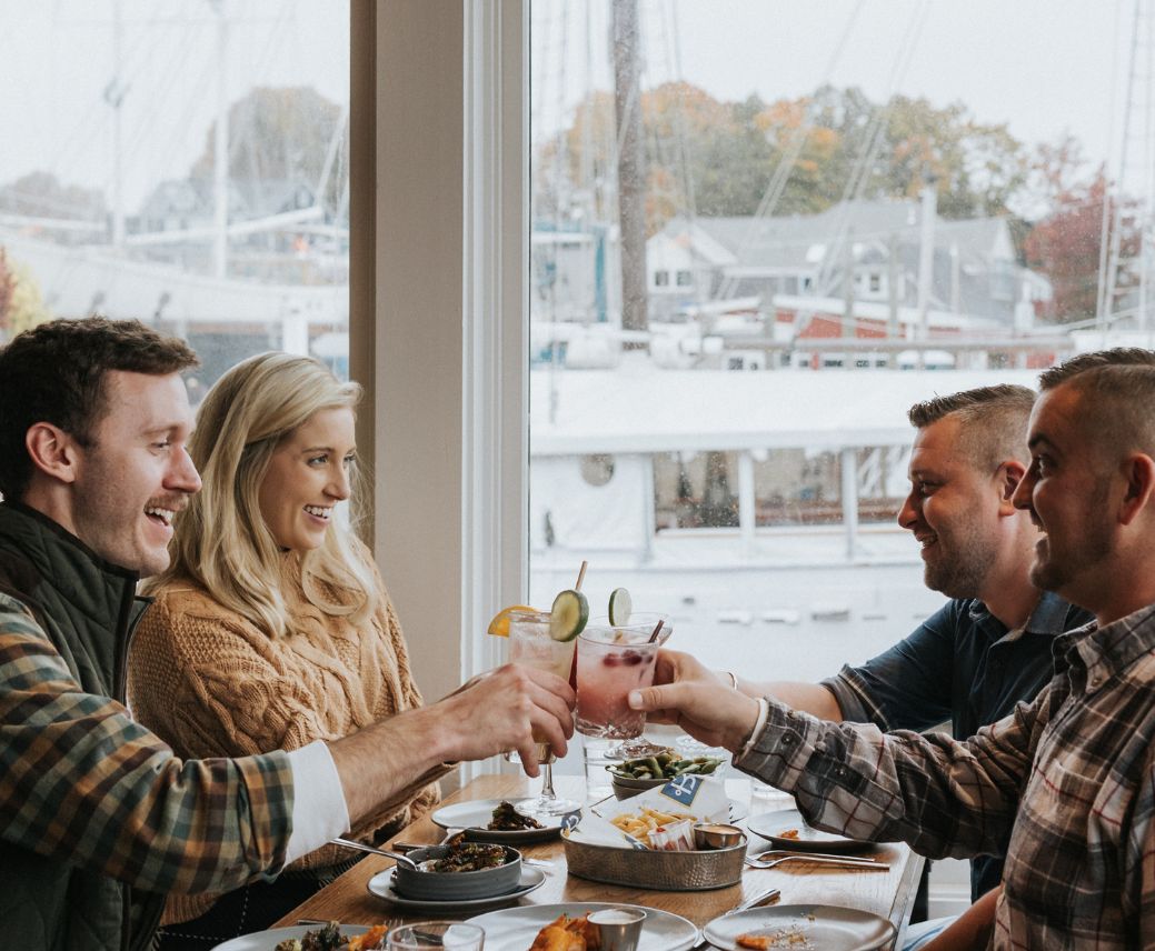 a group of people sitting at a table with drinks