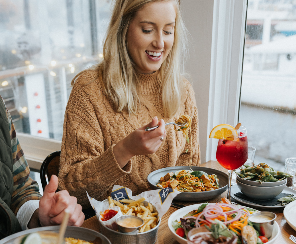 a woman eating at a table