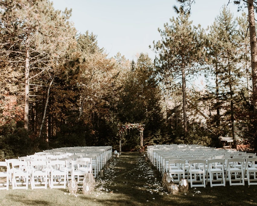 Woodland wedding ceremony at the Ceremony Lawn at Hidden Pond in Kennebunkport, Maine surrounded by gardens and nature