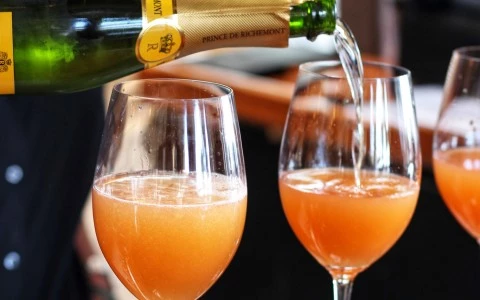 champagne being poured into three wine glasses 