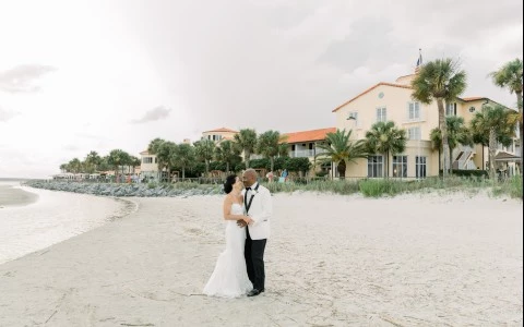 married couple kissing on the beach