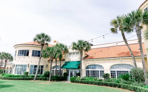 exterior of hotel with twinkly lights and patch of grass