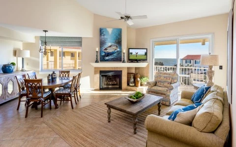 sitting room area with a nice fireplace and a tv on the wall 