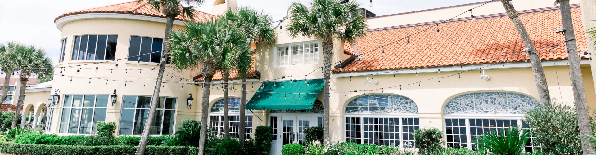 a building with palm trees and lights