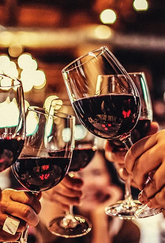 Closeup view of a red wine glasses making a toast