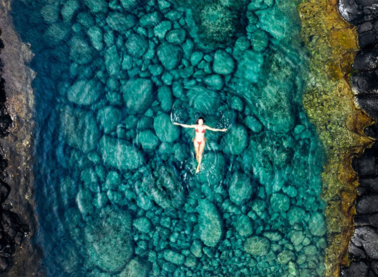 a woman in a garment floating in a body of water