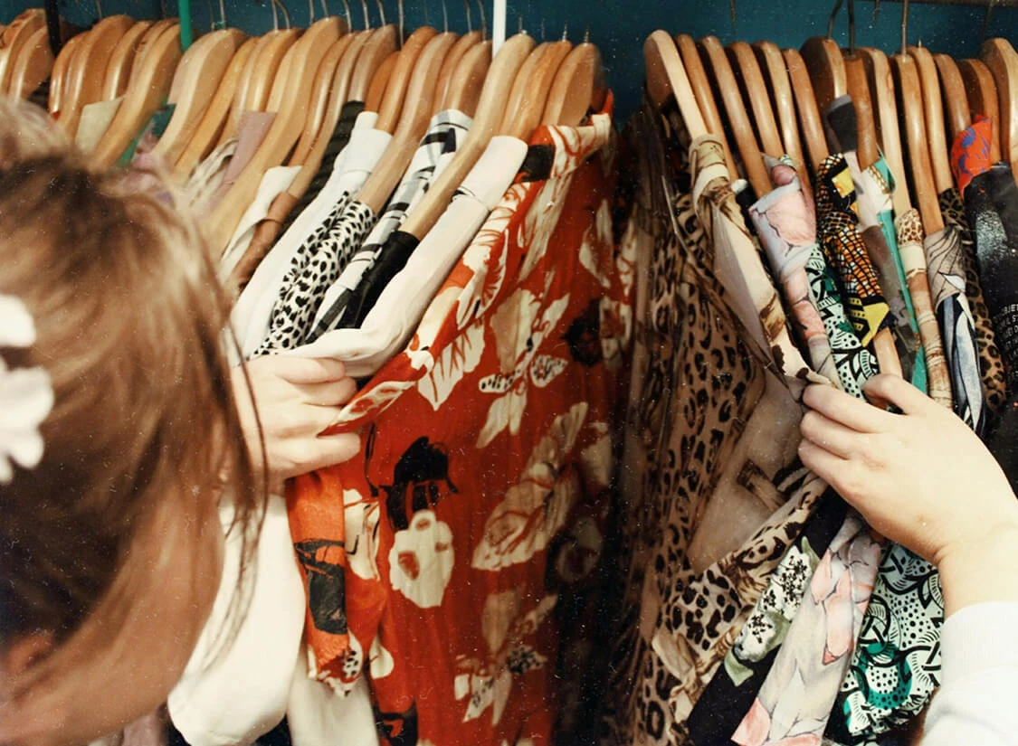 a woman holding a group of clothes
