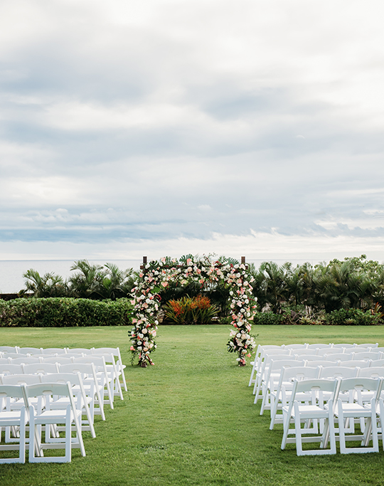 a wedding ceremony with chairs and flowers