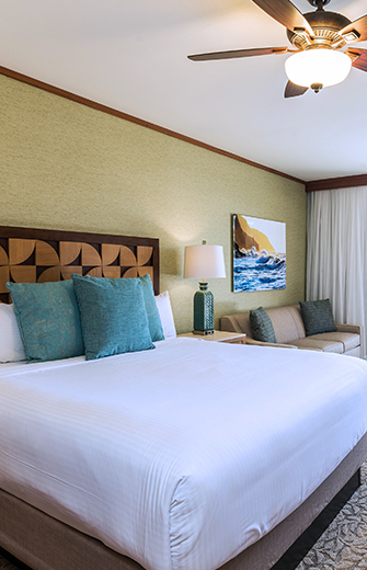 a bed with pillows and a lamp in a room