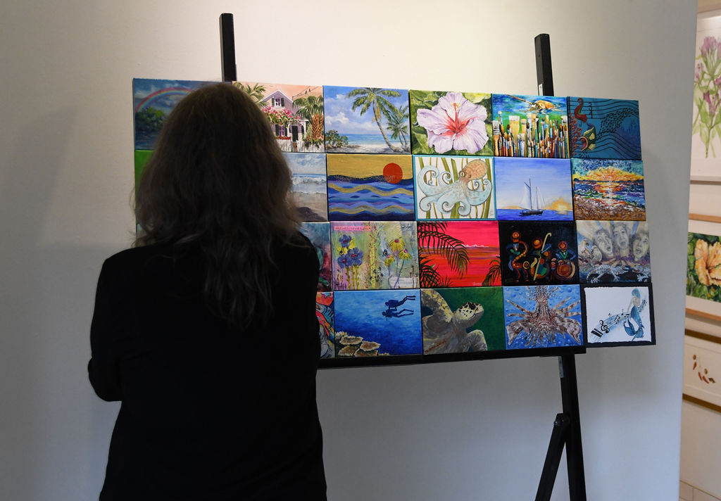 a woman looking at a painting