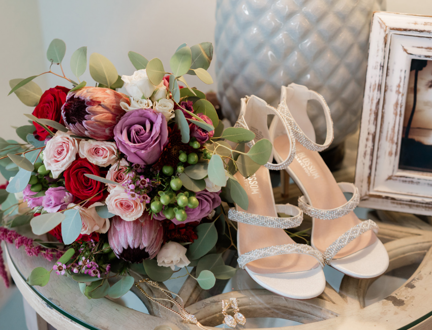 Closeup of a bride wedding shoes and the bouquet