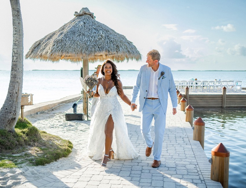 a man and woman walking down a path with an umbrella