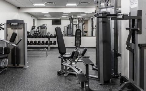 a black and white photograph of a room with a variety of fitness equipment