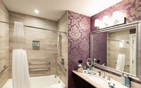 a bathroom with purple and gold designed wallpaper