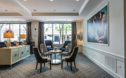 a formal sitting area with soft lighting and artwork on the wall