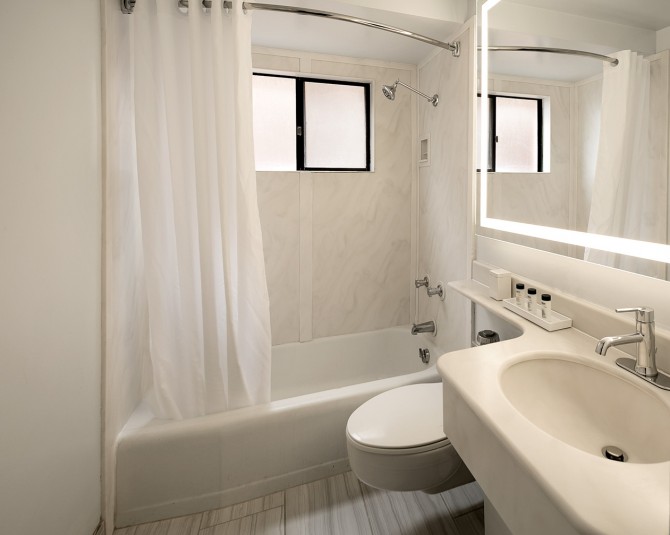 hotel bathroom with small bathroom sink, toilet and tub picture 1