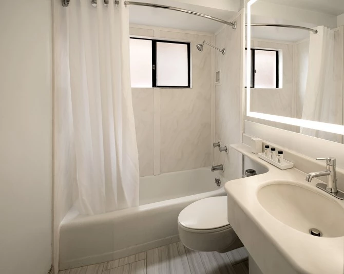 hotel bathroom with small bathroom sink, toilet and tub picture 1