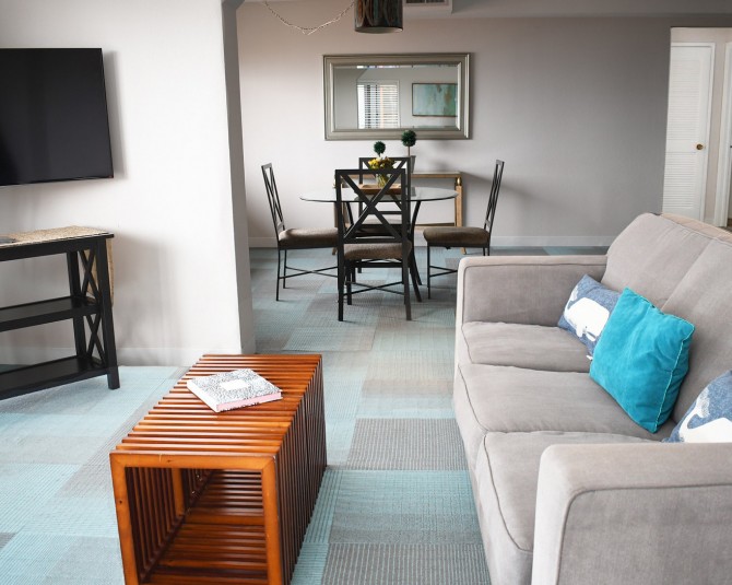 living room area with couch flat screen TV and circle table in dining room picture 0