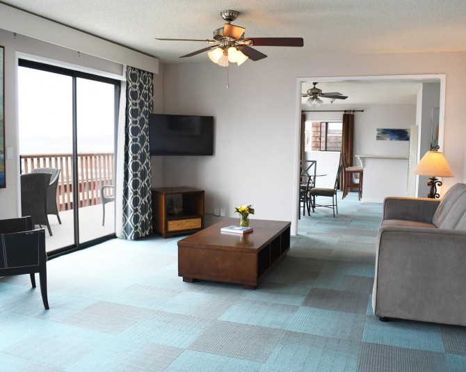 hotel room living room with a couch facing the large windows picture 0