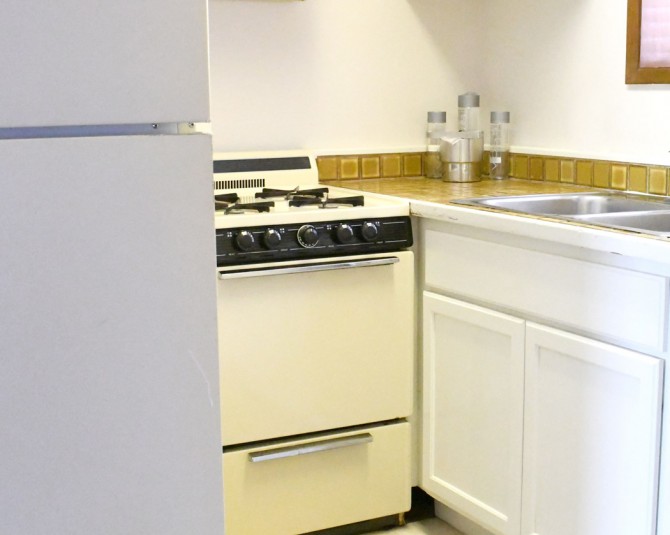 hotel room kitchen with stove, fridge and sink picture 2